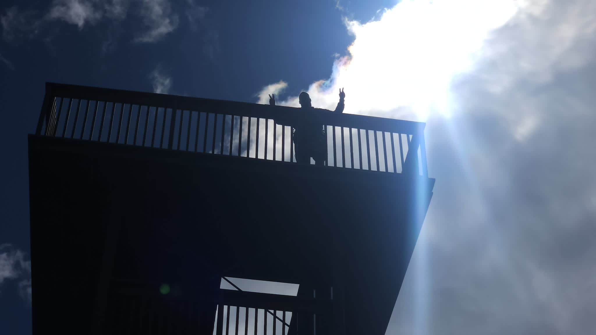 Sylvain outdoors, silhouetted against the sky